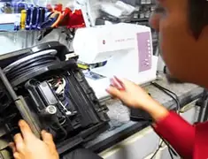 Vacuum repair technician servicing internal components on a workbench in Boston, MA