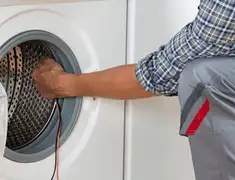 Dryer repair technician diagnosing and servicing a clothes dryer in Boston, MA