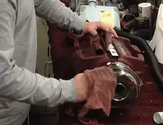 Vacuum repair technician cleaning and servicing a vacuum motor in Boston, MA